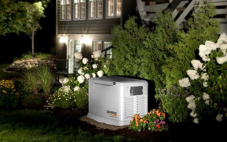 A whole-home standby generator installed beside a house